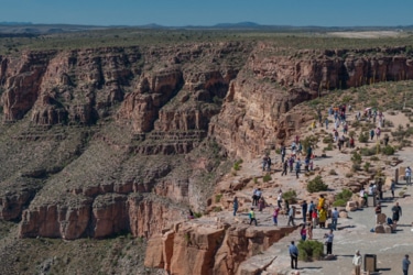 Tourists viewing the Grand Canyon cliffs during a helicopter tour.